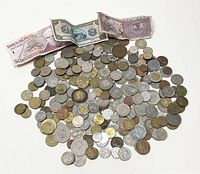 Coins spread out with banknotes