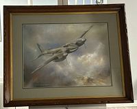 Framed pastel artwork showing full frame and airplane image in a wood frame with gray matting.