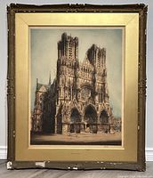 Full view of framed etching depicting Rheims Cathedral with visible wear on the ornate frame.