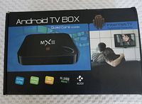 Front of the retail box showing branding and key features: Quad Core CPU, 4 Core GPU, 4K UHD video, H.265 HEVC support, Kodi media gateway compatibility.
