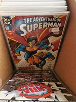 Photo showing The Adventures of Superman #611 at front of lot in box with other bagged comics