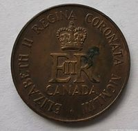 Obverse side of the 1953 Elizabeth II Regina Coronation Canadian coin showing the crowned 'E II R' monogram, the inscription around the edge, and minor discoloration near the crown.
