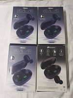 Four unopened boxes of 2Boom Viral Air true wireless earbuds, showing front packaging with earbuds in charging case illustration and branding.