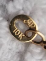 Close-up of stamped gold tag marking 10K