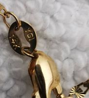 Close-up of chain clasp showing hallmark stamped “14k” and metal links