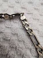 Close-up photo showing 925 Italy marks on the silver chain clasp to verify authenticity.