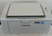 Front view of Samsung ML-2165W printer with closed input tray and device logo visible