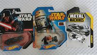 Photo showing three packaged toy vehicles: Star Wars Darth Vader Hot Wheels car, Star Wars R2-D2 Hot Wheels speeder bike, and ZURU Metal Machines Scorpio car.