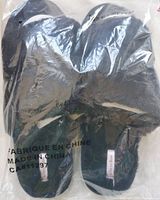 Photo of black La Vie en Rose slippers in original sealed plastic packaging showing product label and size information.