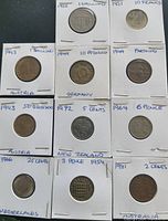 Image showing 12 coins in protective holders, various years and denominations from countries including Austria, Germany, New Zealand, Netherlands, Australia, and others.