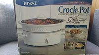 Boxed Rival Crock-Pot slow cooker showing branding, 4.7L capacity and cooking pot image.