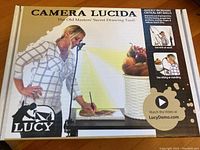 Box front showing Camera Lucida drawing tool branding and marketing images.