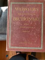 Front cover of Webster's New Twentieth Century Dictionary, showing embossed gold lettering on brown hardcover.