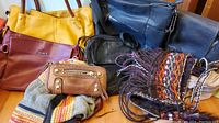 Photo showing all purses and bags together with visible details on materials and colors