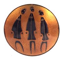 Top-down view of round copper enamel pin dish showing three black enamel figures with gold accents against textured copper background.