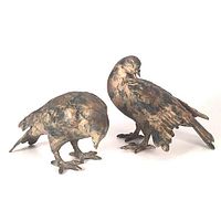Both bronze pigeon sculptures side by side showing overall appearance and finish