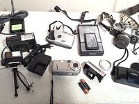 Photo showing all 5 cameras, battery chargers, flash units, and camera straps.