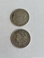 Obverse side of the two coins showing the Lady Liberty design and dates 1885 and 1902.