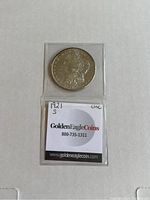 Front side of 1921 S Morgan Silver Dollar coin in clear protective sleeve with Golden Eagle Coins label visible.