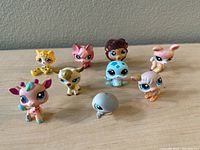Group shot of all 8 Littlest Pet Shop animal figures with various species and colors.