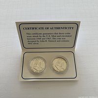Two Franklin half dollar silver coins from 1951 and 1954 in clear plastic holders displayed with Certificate of Authenticity stating coin composition and design details.