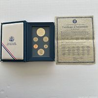 Photo showing the blue presentation box containing six proof coins and the Certificate of Authenticity.