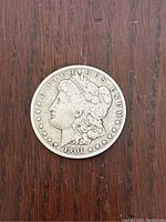Front side of 1901 Morgan Dollar showing Lady Liberty's profile with inscriptions and stars.