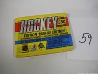 Photo of sealed 1989-90 O-Pee-Chee hockey mini card pack in yellow, red, and blue colors with text about contents.