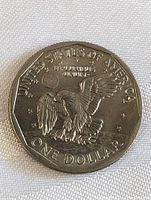 Clear photo of the coin reverse showing an eagle landing on the moon with earth in the background and inscriptions.