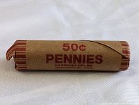 Photo of one penny roll wrapped in brown paper labeled 50¢ Pennies, manufactured by N. R. String & Son, Inc.