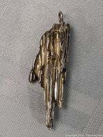 Front angle of sterling silver designer pendant with raw crude style