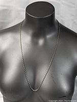 Sterling silver necklace displayed on black mannequin bust, showing full length and clasp area partially visible.