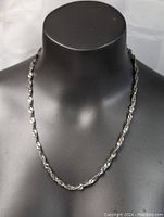 Full view of sterling silver twist necklace on mannequin showing length and overall look.