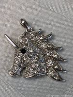 Close-up image of the sterling silver unicorn pendant showcasing the detailed mane and crystal encrustments.