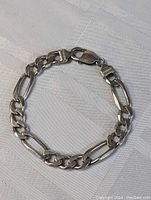 Full view of the sterling silver chain bracelet laid flat, showing overall length and link style.