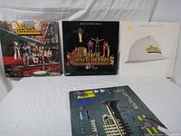 Front view of 4 Brass Construction albums showing colorful album covers with band photos and artistic designs
