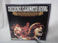 Front cover of the Credence Clearwater Revival vinyl album 'Chronicle The 20 Greatest Hits' showing band images and title text.