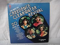 Front cover of Creedence Clearwater Revival 20 Greatest Hits vinyl LP showing band member photos and album title.