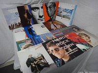 Photo showing all 18 vinyl album covers arranged facing forward with visible titles and artwork.