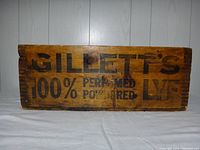 Photo of the wooden box front showing Gillett's printed advertisement text
