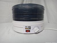 Photo of Salton VitaPro food dehydrator front view showing stacked dark blue plastic drying trays and white base unit.