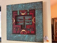 Full frontal photo of the square Southwestern dragonfly wall art showing the central dragonflies and the detailed copper outer frame.