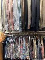 Overview of men's long-sleeve dress shirts on upper rack and short-sleeve country/floral shirts on lower rack