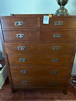 Front view of eight-drawer brown wooden chest