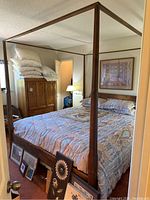 Full view of assembled king size four-poster bed frame from footboard side showing posts, side rails and canopy rails