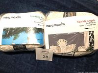Two sealed Mary Maxim crochet kits in original packaging showing labels and product names.