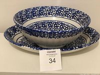Blue spongeware bowl resting inside the matching oval platter, showing sponge pattern on rims, displayed with lot number card in front