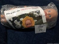 Plastic doll sealed in plastic bag with Mary Maxim Little Miss Sunshine Doll Kit label.