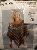 Packaging showing model wearing the finished poncho design and kit details including sizes and brand.