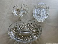 Three clear glass relish plates viewed from the top, showing overall design and divided sections.
